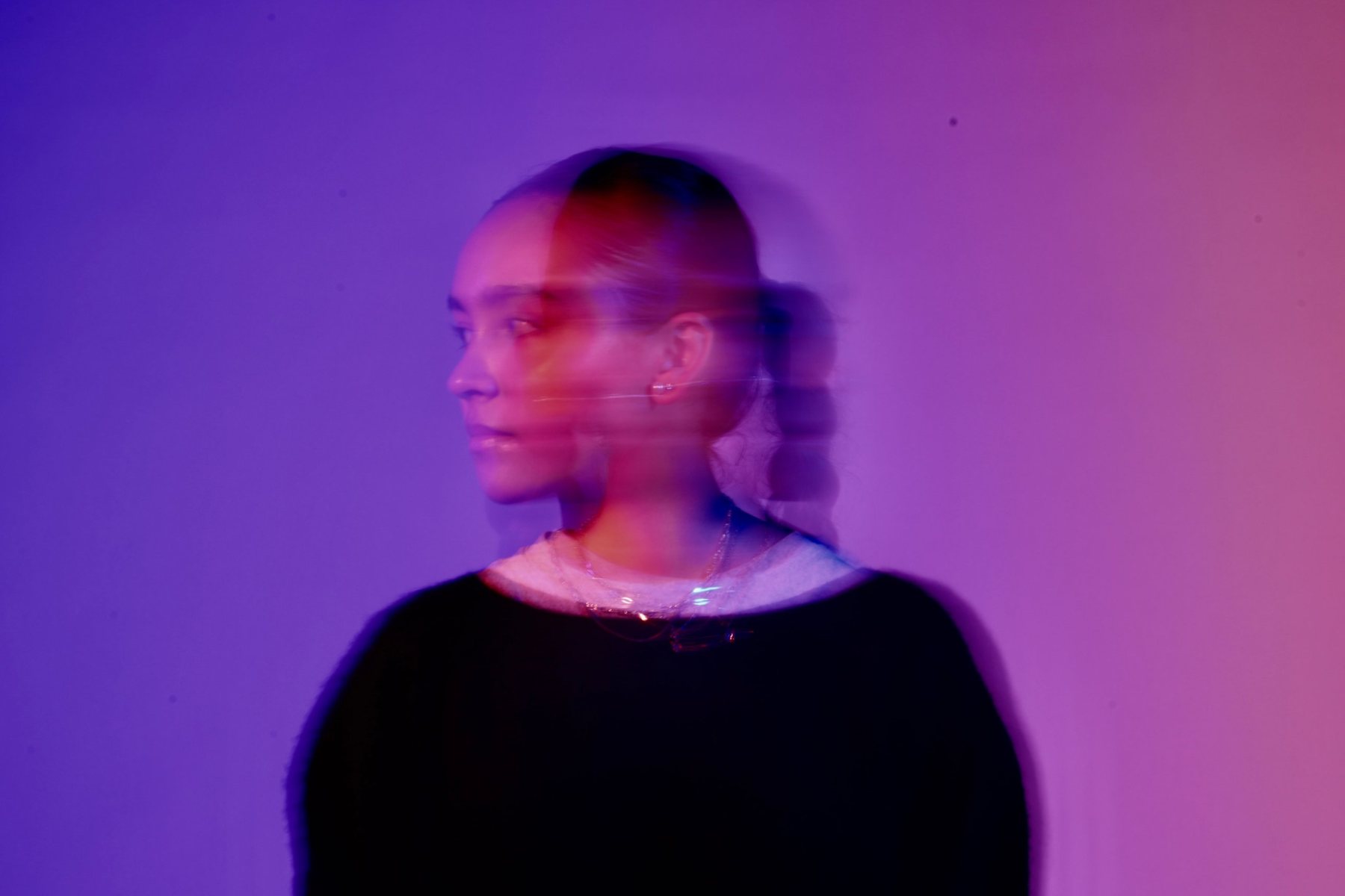 Cover: profile portrait with streaked motion blur against a violet to pink wall