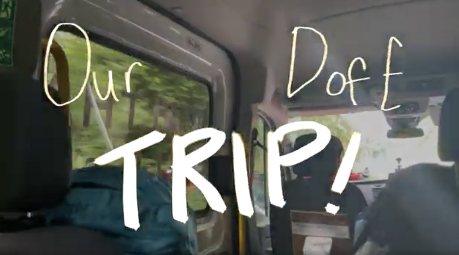 Title card from the DofE film: Our DofE Trip, over footage inside a minibus